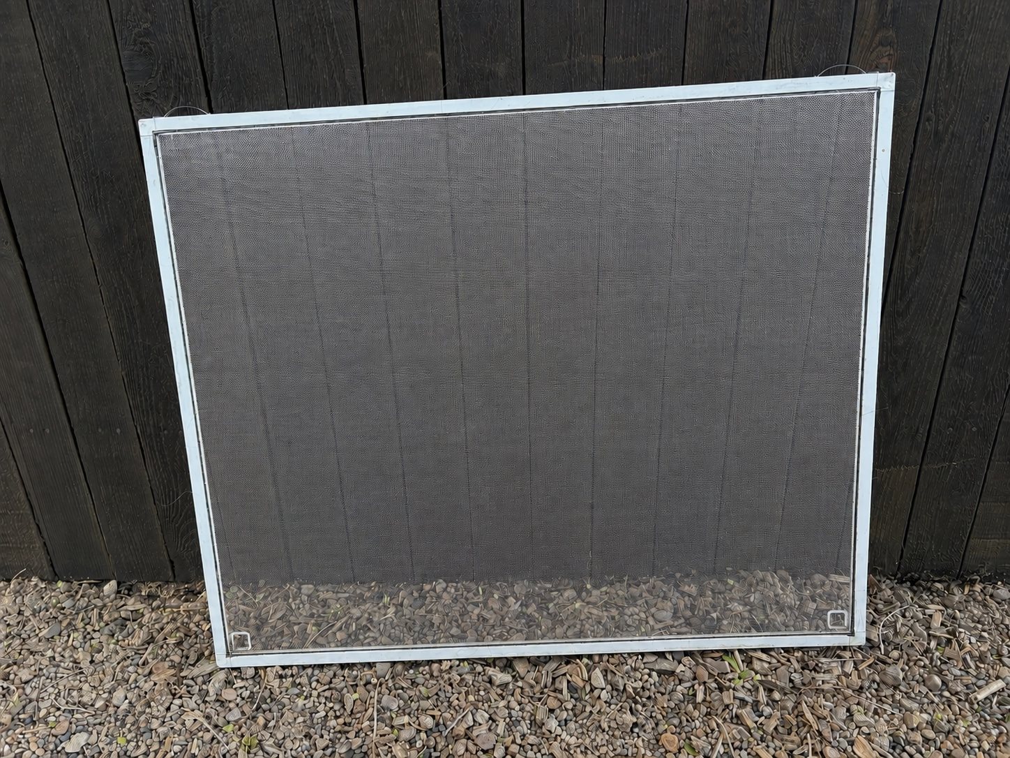ClearView replacement screen leaning against a fence